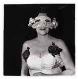 Diane Arbus, Lady at a masked ball with two roses on her dress, N.Y.C.