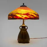 Continuous Wave table lamp by Brass Pittsburgh Lamp & Glass Company, c. 1920, reverse and obverse-painted textured glass, patinated metal, sold Dec 2023