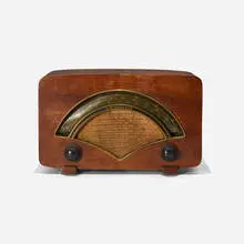 radio, model 8H034 by Charles and Ray Eames, 1946, walnut plywood, brass, upholstery, Bakelite, sold Feb 2017