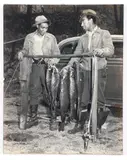 Charles Harris, (African-American/Pittsburgh, 1908-1998), Two men with string of five large fish in a back yard on a hillside, taken 1940-1950, printed later, silver gelatin