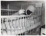 Charles Harris, (American/Pittsburgh, 1908-1998), Eleven-year-old Willie Fletcher, heavily bandaged from burns, lying in hospital bed in Braddock General Hospital, taken