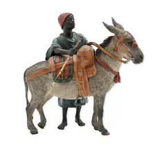 Franz Xaver Bergman, Figure with Donkey A finely cast and cold-painted, bronze group depicting a young North African figure standing beside a saddled an
