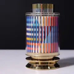 Kiddush Cup by Yaacov Agam, 1993, 24k gold-plated sterling silver cup encased in an acrylic cylinder with an Agamograph lent, sold Feb 2026