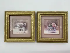 Marilyn Simandle, This charming pair of framed prints features delicate floral teacups illustrated by American artist Marilyn Simandle. Each piece presents a finely detailed watercolor style rendering of a porcelain teacup with blooming floral patterns, Lithograph