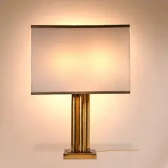 Brass table lamp by Romeo Rega, 1970, Brass and plexiglass lamp.Signature "Romeo Rega" engraved on side.Hollywood Regency Style, offered Jul 2023