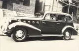 Charles Harris, (American/Pittsburgh, 1908-1998), Man seated in 1930s Buick Roadmaster sedan, on residential street, possibly Mulford Street, Homewood, taken