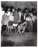 Charles Harris, (American/Pittsburgh, 1908-1998), City of Pittsburgh Marbles Champion Howard Hawkins with Children Gathered Behind Him, taken 1948, printed c.1980s, matte