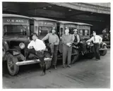 Charles Harris, (African-American/Pittsburgh, 1908-1998), Five men with U. S. Mail delivery vehicles in post office loading dock, taken c.1949, printed later