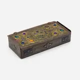 Art Nouveau lidded box with stylized mythical creatures by attribution Alfred-Louis-Achille Daguet, c. 1910, patinated, hammered and enameled brass, hammered iron, glass cabochons, sold Mar 2023