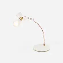Lucellino table lamp by Ingo Maurer, 1992, molded plastic, brass, light bulb, feathers, plastic coated wire, sold Jan 2017