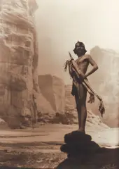 Roland W. Reed, Son of Manuelito, Navajo [The Statue of the de Chelly], taken 1913, sepia tinted, photograph on textured paper, Reed's signature and date printed in the