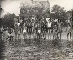 Lawren Harris, Teenie (American/Pittsburgh, 1908-1998), Group of Children Posed under Shower from Fire Hydrant, taken 1947, printed c.1980s, matte, photograph