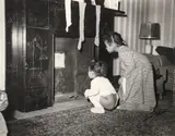 Teenie (American/Pittsburgh, 1908-1998), Two Young Girls Waiting for Santa Claus, taken c. late 1940s, printed c.1980s, matte by Lawren Harris, photograph, offered Sep 2023