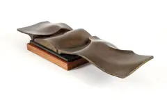 Ron Bennett, Landscape Forms, cast, bronze on a wood base, 16.25 W x 4.5 D x 2.5 T inches. Provenance: from the esta