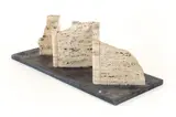Henry Bursztynowicz, Archaeological Site (Folded Slab Number 3), circa 1980, polished and, carved travertine marble on a slate base