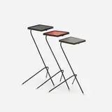 Mathieu Matégot and Floris Fiedeldij, set of three nesting tables, c. 1955, enameled and perforated steel, plastic