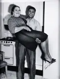 Charles Harris, Boxer Muhammad Ali (Cassius Clay) lifting his mother Odessa Grady Clay, in room at Carlton House Hotel