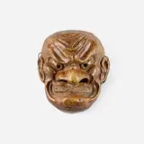 Japonesque wall-hanging mask (Grimacing Tengu) by attribution Armand Rousseau for Atelier de Breteuil, c. 1900, glazed stoneware, sold Mar 2026