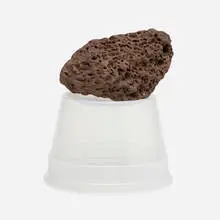 Tony Feher, Untitled (CFMX 75), 2004, intrusive basaltic rock, approximately 30 million years old, and inverted 16 oz. #5 polypropylene deli container of a contemporary date