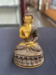 A Chinese, Untitled, bronze statue of seated buddha
