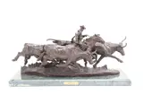 Featured in this lot is this by Frederic Remington, bronze, offered Mar 2022