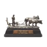 Carl Kauba, patinated bronze model of a ploughing team on ebonised plinth base, patinated bronze