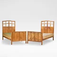 Gordon Russell, Pair of single beds, circa 1929, Walnut, the latticed headboards with arched cornices, the head and footboards both panelled with cedar and boxwood strung surround