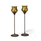 American Arts and Crafts, Pair of Candlesticks, patinated bronze bases with Quezal decorated glass shades, each shade inscribed 'Quezal'