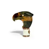 the agate carved in the shape of an eagle's head with diamond eyes mounted on a white guilloché enamel cylindrical handle bordered at the top and bottom with a scrolling foliate motif, bearing spurious marks for workmaster August Holmström by Silver-mounted agate and white enamel parasol handle in Fabergé style, offered Feb 2025