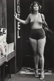 Leon Levinstein, NYC [woman in hotel entry], c. 1970, Gelatin silver print; Leon Levinstein stamp in ink on the verso
