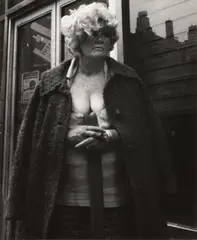 Leon Levinstein, NYC [woman with overcoat], c. 1970, Gelatin silver print; Leon Levinstein stamp in ink on the verso