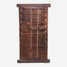 Door with wall supports by Dogon, carved and stained wood, sold Oct 2024