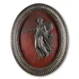 England, late 18th century, by Wedgwood Black Basalt Self-framed Plaque, the oval with iron red ground to a high relief Herculaneum maiden, unmarked,  lg, sold Jul 2024