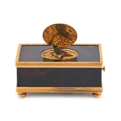 Swiss Singing Bird Automaton Box, rectangular and brass mounted, the lid lifts to reveal a chirping bird, manufactured by Reuge Music,  ht. 2, wd. 4 1/2, dp. 2 3/4 in., rectangular and brass mounted, the lid lifts to reveal a chirping bird, manufactured by Reuge Music,  ht