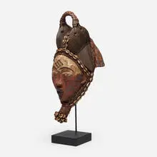 Mukudj mask by Punu artist, carved wood, pigment, beads, shells, bamboo, fiber, cloth, sold May 2024