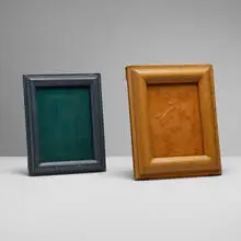 Picture frames, set of two by Jacques Adnet, c. 1950, saddle-stitched leather over wood, glass, sold Apr 2024