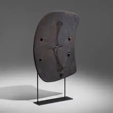Lumi shield by Papuan, painted and carved wood, wicker, enameled steel, sold Feb 2024