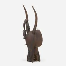 Kponyugo (firespitter mask) by Senufo, carved wood, pigment, sold Oct 2021