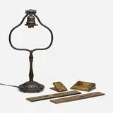 Bell-shaped lamp base and Grapevine desk accessories by Tiffany Studios, c. 1906-1920, patinated bronze, gilt bronze, hand-blown Favrile glass, sold Oct 2023