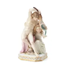 Meissen, Porcelain Group of Two Youths, polychrome enameled and gilded, the nude boy modeled pouring water through a horn, being caught by a girl, crossed swords mark, ht