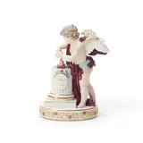 Meissen, Porcelain Cupid Figure with Motto, polychrome enameled and gilded, the standing figure modeled pouring water on flaming hearts