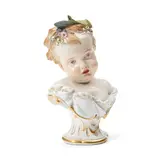 Meissen, Porcelain Bust of a Child, polychrome enameled and gilded, modeled with large leaves atop the head and with flowers about her forehead, crossed swords mark, ht