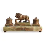 England, mid-19th century, by Victorian Onyx and Bronze Inkstand, the onyx inkstand with central bronze lion on plinth flanked by two chased bronze inkwells, above an ovular well for pen, sold Jul 2023