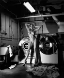 ’Domestic Nude III’ in the laundry room, Chateau Marmont, Hollywood by Helmut Newton, 1992, Silbergelatineabzug, sold May 2014