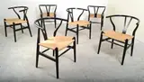 A SET OF SIX CH24 WISHBONE CHAIRS by Hans J. Wegner, ebonised wood, papercord, sold Mar 2013