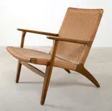 Hans J. Wegner, A CH25 ARMCHAIR, designed, c.1950, stained beech, papercord