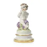 Meissen, Porcelain Figure of a Bound Cupid, polychrome enamel decorated and gilded with a figure seated atop a domed base, crossed swords mark, ht