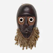 Gunyege mask by Dan, carved and painted wood, silver, braided twine, feathers, sold Jul 2021