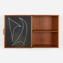 Wall-mounted cabinet by Kai Kristiansen, c. 1950, walnut, lacquered wood with aluminum inlay, sold Jul 2021