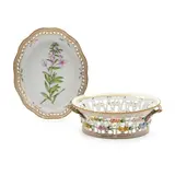Royal Copenhagen, Flora Danica Porcelain Fruit Basket and Under Dish, oval shape with pierced body and twig handles, gilded trim and polychrome enameled, the basket with violets, rim 9 3/8, lg